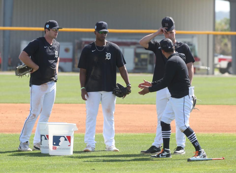 (From left) Tigers infielders Colt Keith, Justyn-Henry Malloy and Andre Lipcius listen to a coach during spring training on Monday, Feb. 20, 2023, in Lakeland, Florida.