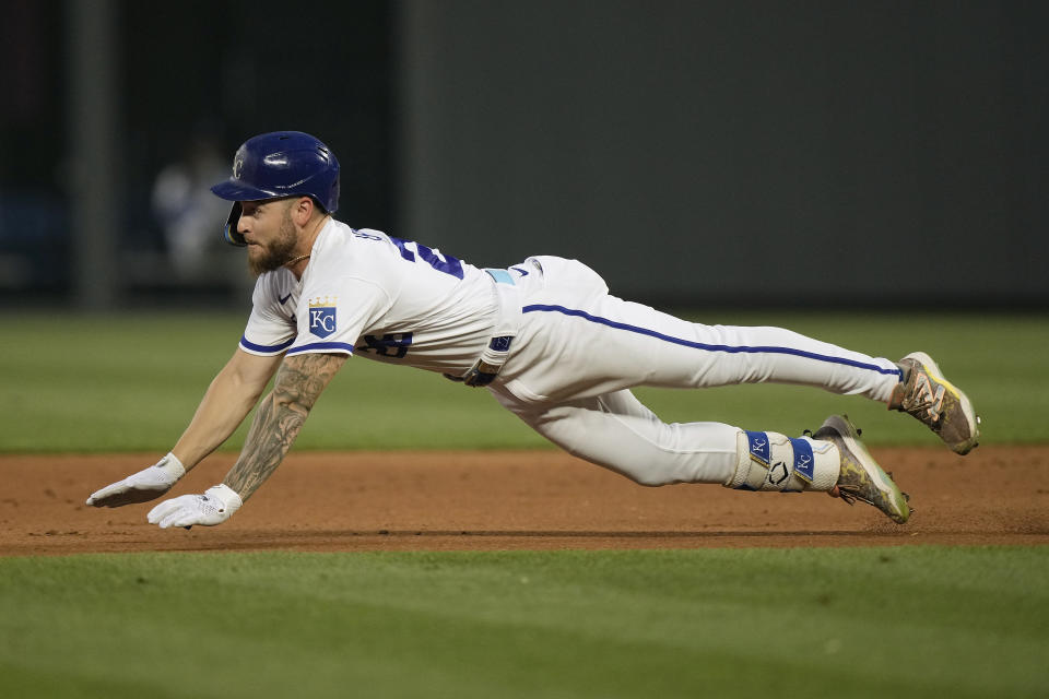 Kansas City Royals' Kyle Isbel dives to second after hitting an RBI double during the fifth inning of a baseball game against the Detroit Tigers Wednesday, July 19, 2023, in Kansas City, Mo. (AP Photo/Charlie Riedel)