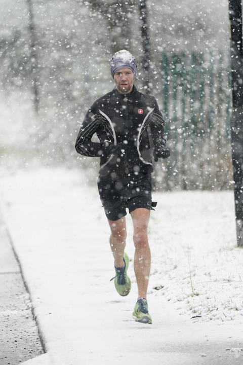 A man runs in the snow in Knaresborough. (Getty)