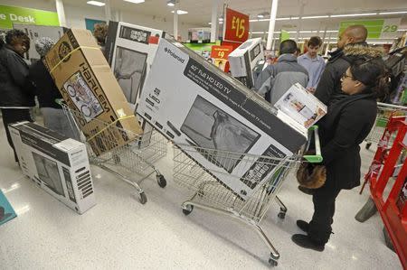 Shoppers queue to purchase retail items on "Black Friday" at an Asda superstore in Wembley, north London November 28, 2014. REUTERS/Luke MacGregor