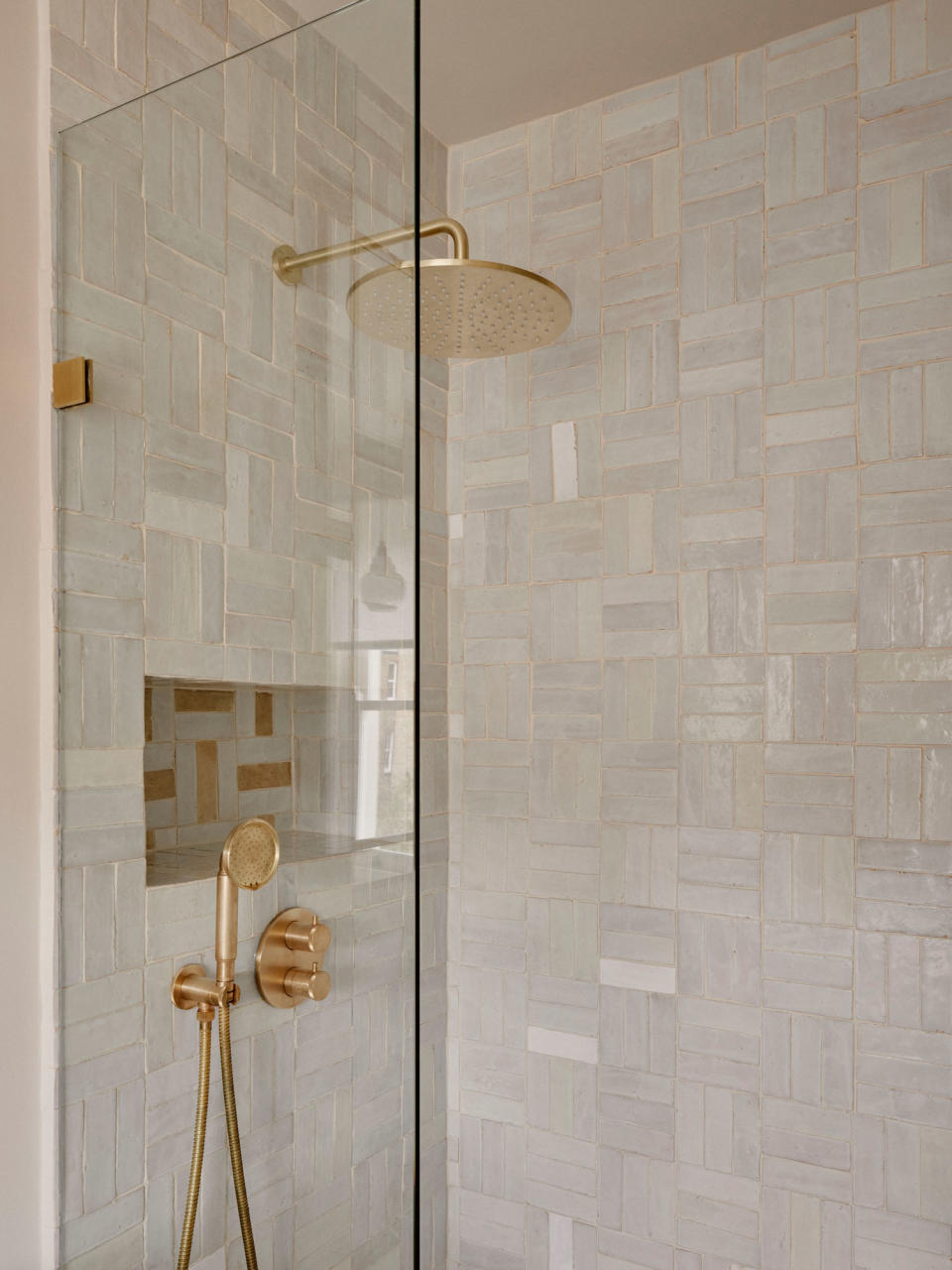 A bathroom with a zellige tiled shower