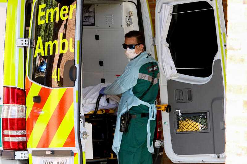 A paramedic wears protective clothing while outside the Mount Barker Hospital in Adelaide