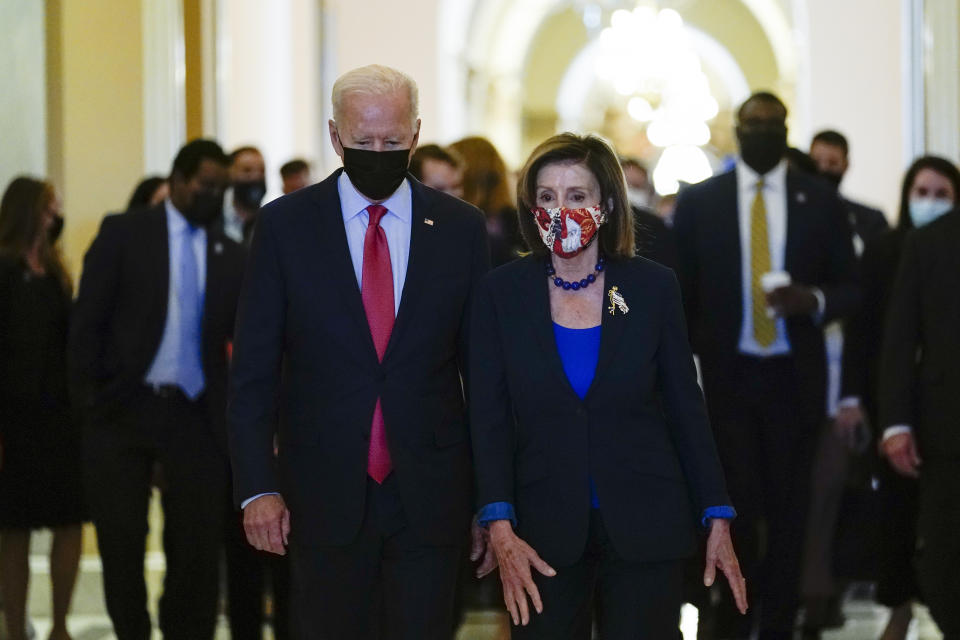 President Joe Biden walks with House Speaker Nancy Pelosi of Calif., on Capitol Hill in Washington, Friday, Oct. 1, 2021, after attending a meeting with the House Democratic caucus to try to resolve an impasse around the bipartisan infrastructure bill. (AP Photo/Susan Walsh)