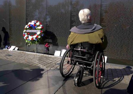 U.S. Marine combat veteran Charlie Wittwer pays his respects at the National Vietnam Veterans Memorial on Veteran's Day in Washington, November 11, 2014. REUTERS/Larry Downing