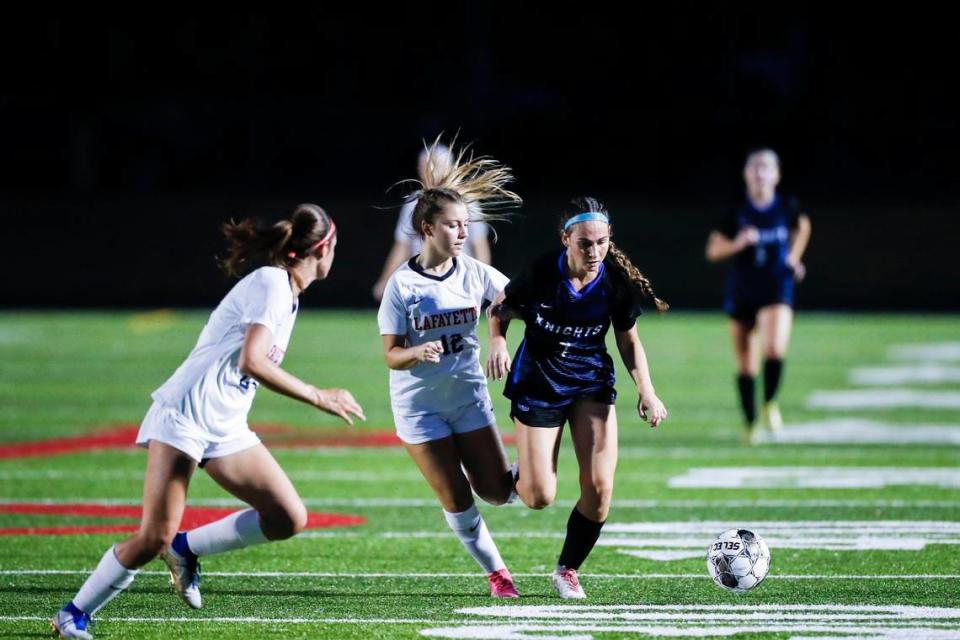 Lexington Catholic’s Sydney Elbert (7) moves the ball upfield against Lafayette’s Eva King (12) during the 43rd District girls soccer tournament championship game at Lafayette on Wednesday.