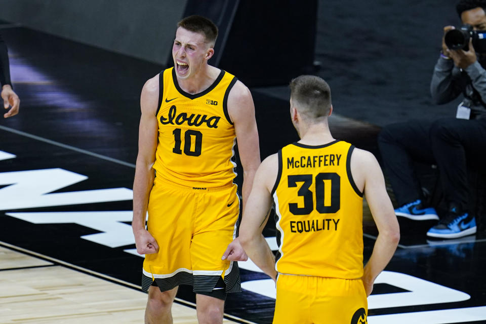 Iowa guard Joe Wieskamp (10) celebrates with guard Connor McCaffery (30) after blocking a shot in the closing minute of the team's NCAA college basketball game against Wisconsin at the Big Ten Conference men's tournament in Indianapolis, Friday, March 12, 2021. Iowa won 62-57. (AP Photo/Michael Conroy)