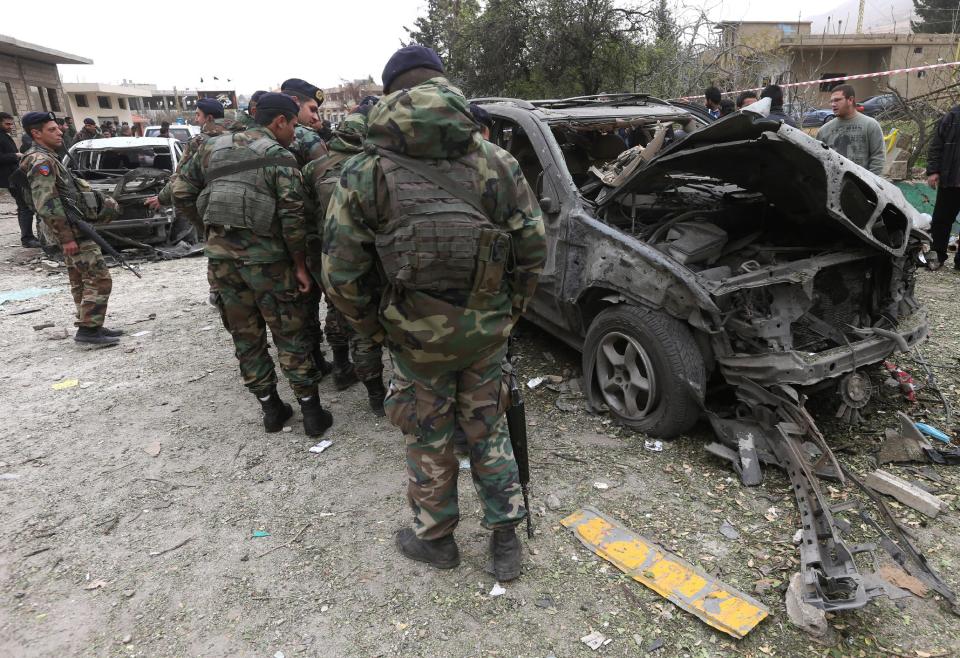 Lebanese army soldiers check damaged cars at the site of a deadly car bombing Sunday night, in the town of Nabi Othman, about 30 kilometers (18 miles) north of Baalbek, northeast Lebanon, Monday March 17, 2014. Lebanese security officials said the explosion killed at least two people and caused panic and massive destruction in the Hezbollah stronghold, which has a sizable Christian population in addition to Shiites. The civil war in neighboring Syria already has ignited polarizing sectarian tensions between Lebanon's Sunnis and Shiites. (AP Photo/Hussein Malla)