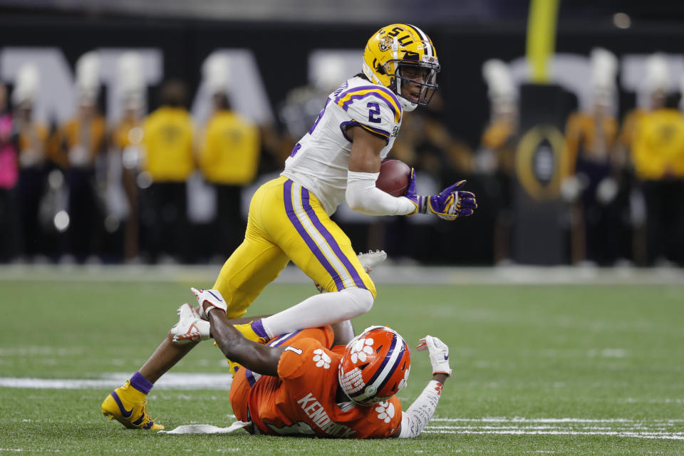 LSU wide receiver Justin Jefferson runs over Clemson cornerback Derion Kendrick during the first half of a NCAA College Football Playoff national championship game Monday, Jan. 13, 2020, in New Orleans. (AP Photo/Gerald Herbert)