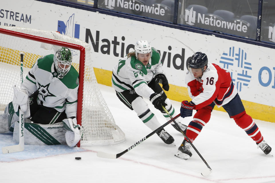 Columbus Blue Jackets' Max Domi, right, shoots on Dallas Stars' Jake Oettinger, left, as Roope Hintz defends during the second period of an NHL hockey game Tuesday, Feb. 2, 2021, in Columbus, Ohio. (AP Photo/Jay LaPrete)