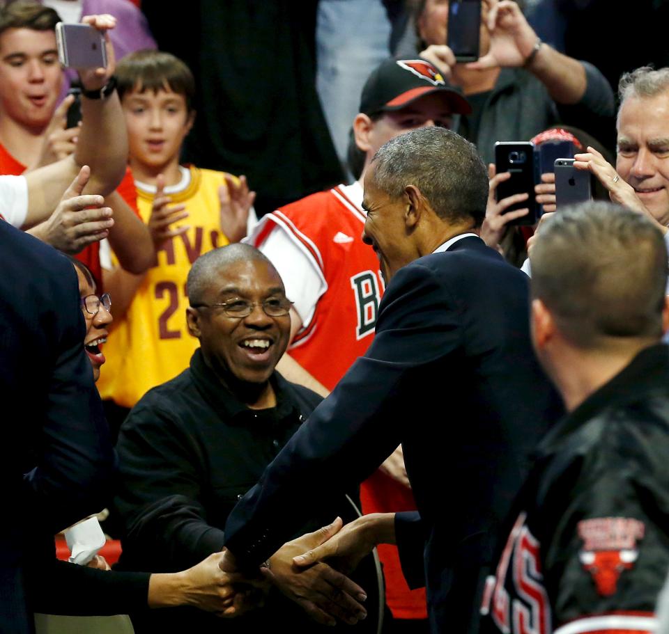 U.S. President Barack Obama (back to camera) greets fans as he attends an NBA opening night game between the Cleveland Cavaliers and the Chicago Bulls in Chicago October 27, 2015. Earlier Tuesday Obama delivered remarks at an International Association of Chiefs of Police (IACP) conference and attended Democratic Party events in Chicago. REUTERS/Jonathan Ernst