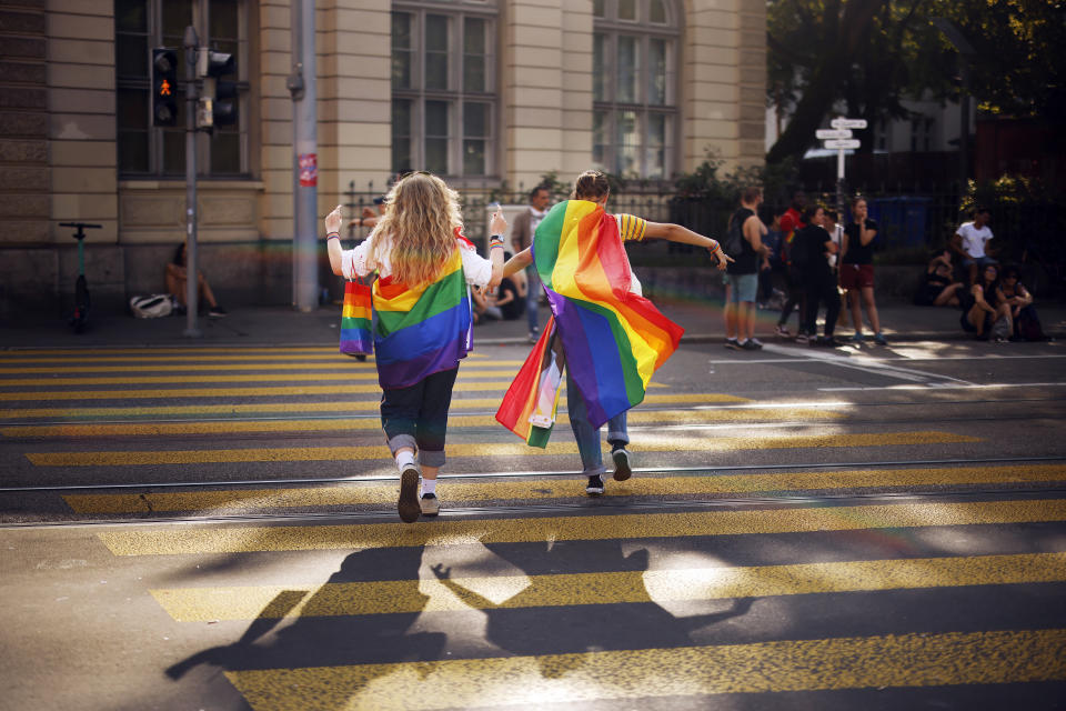 FILE - In this Saturday, Sept. 4, 2021 file photo, people take part in the Zurich Pride parade in Zurich, Switzerland, with the slogan "Dare. Marriage for all, now!" (Trau Dich. Ehe fuer alle. Jetzt!) for the rights of the LGBTIQ community. Swiss voters will wrap up a referendum on Sunday Sept. 26, 2021, to decide whether to allow same-sex marriage in the rich Alpine country, with supporters hoping for a big step toward ending discrimination against gays and lesbians while opponents fear what they consider an erosion of traditional family values. (Michael Buholzer/Keystone via AP, File)