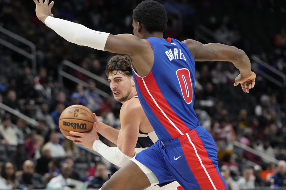 Washington Wizards forward Deni Avdija is defended by Detroit Pistons center Jalen Duren (0) during the first half of an NBA basketball game, Monday, Nov. 27, 2023, in Detroit. (AP Photo/Carlos Osorio)