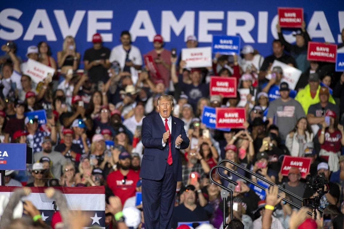 Former President Donald Trump applauds Saturday while speaking at a rally at the Minden Tahoe Airport in Minden, Nev.