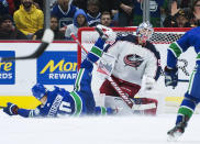 Vancouver Canucks center Elias Pettersson (40) sends a shot past Columbus Blue Jackets goaltender Elvis Merzlikins (90) during the third period of an NHL hockey game in Vancouver, British Columbia, Sunday, March 8, 2020. (Jonathan Hayward/The Canadian Press via AP)