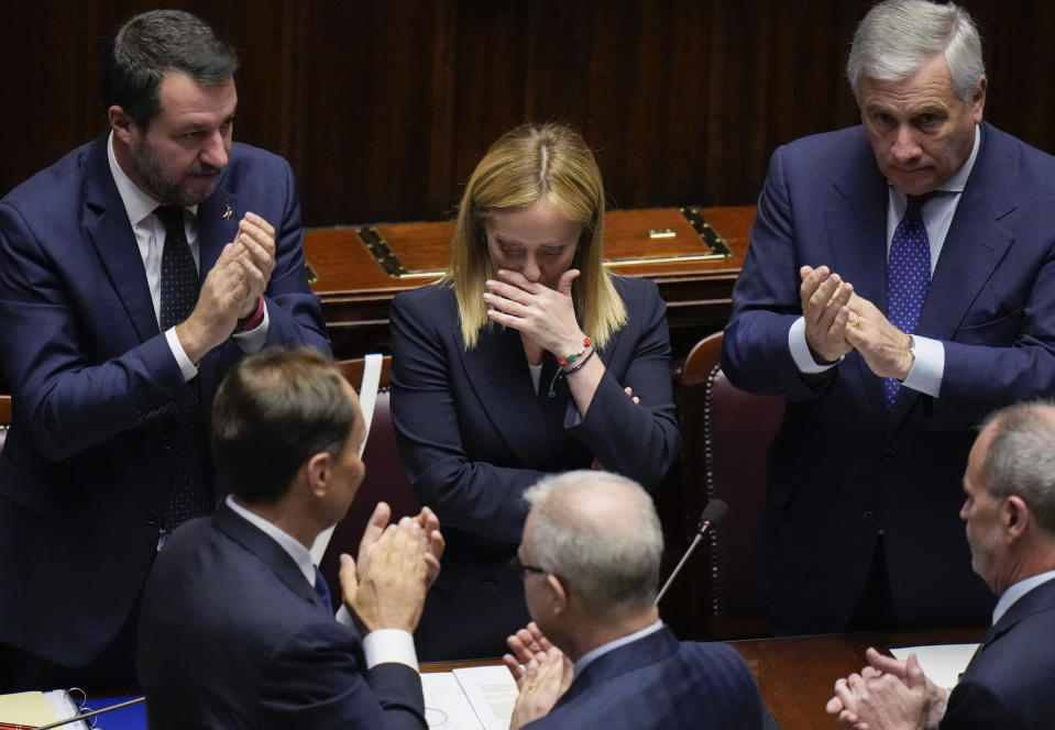 Italian Premier Giorgia Meloni, center, reacts after addressing the lower Chamber ahead of a confidence vote for her Cabinet, Tuesday, Oct. 25, 2022. Giorgia Meloni, whose party with neo-fascist roots finished first in recent elections, is Italy's first far-right premier since the end of World War II. She is also the first woman to serve as Italian premier. At right Foreign Minister Antonio Tajani and at left, Infrastructures Minister Matteo Salvini. (AP Photo/Alessandra Tarantino)