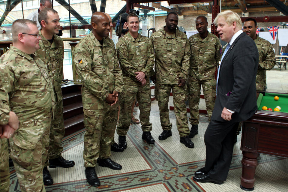 London Mayor Boris Johnson talks to members of the armed forces during a visit to Tobacco Dock, Wapping, as a thank you for their help in making the London 2012 Olympic Games secure.