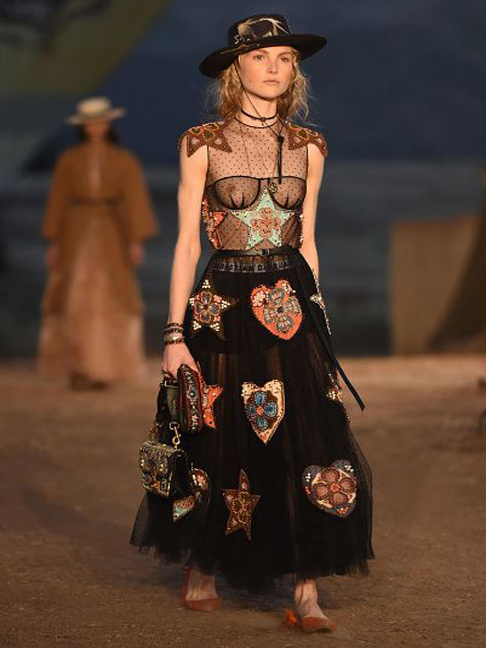 <p>Anders sah es bei Dior aus. Von Paris an die Westküste: Dior-Designerin Maria Garzia Chiuri brachte die Zwischenkollektion des Labels in die Santa Monica Mountains – ein Wüsten-Setting passend für ihre Wild-Western-Looks, die teilweise recht tief blicken ließen wie dieses transparent-bestickte Dress. (Bild-Copyright: Getty Images via Yahoo Canada) </p>