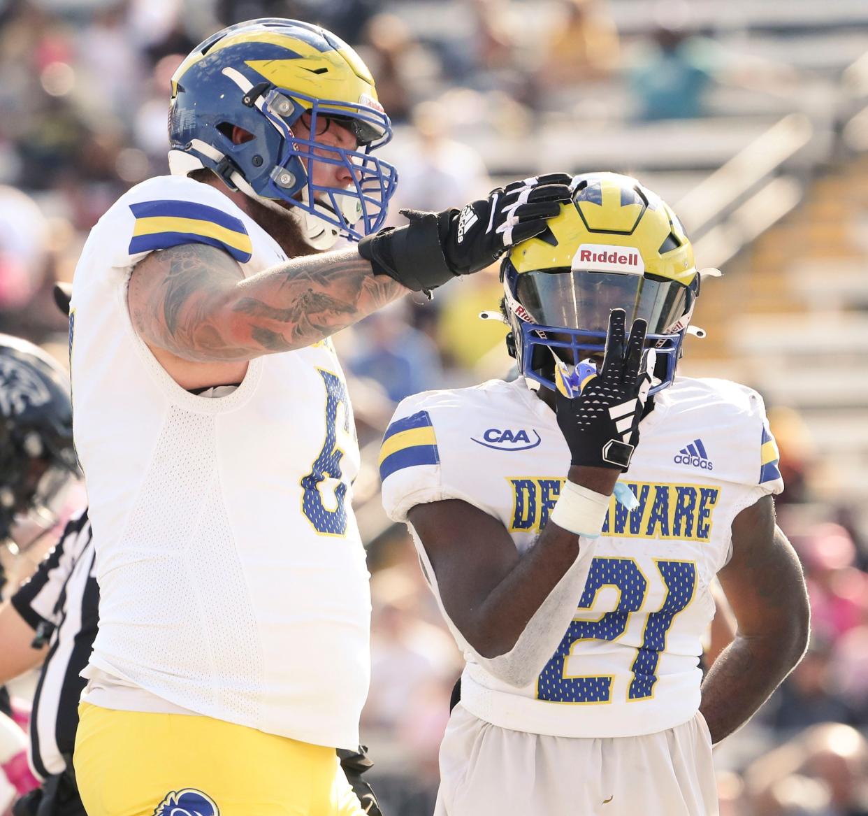 Delaware's Blaise Sparks (left) and Marcus Yarns enjoy Yarns' third score of the first quarter and a 20-0 lead against Towson at Johnny Unitas Stadium in Towson, Md., Saturday, Oct. 28, 2023.