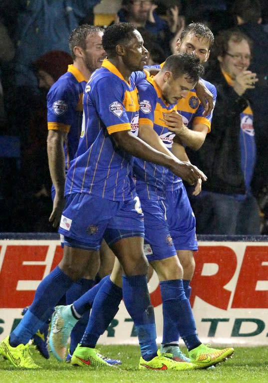 Shrewsbury Town players celebrate a goal against Chelsea during their English League Cup fourth round match at the Greenhous Meadow stadium in Shrewsbury, West Midlands, in October 2014