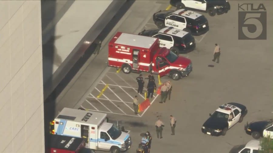 Law enforcement surrounds an ambulance at USC Medical Center that had delivered an officer injured in El Monte on June 14, 2022 (KTLA)
