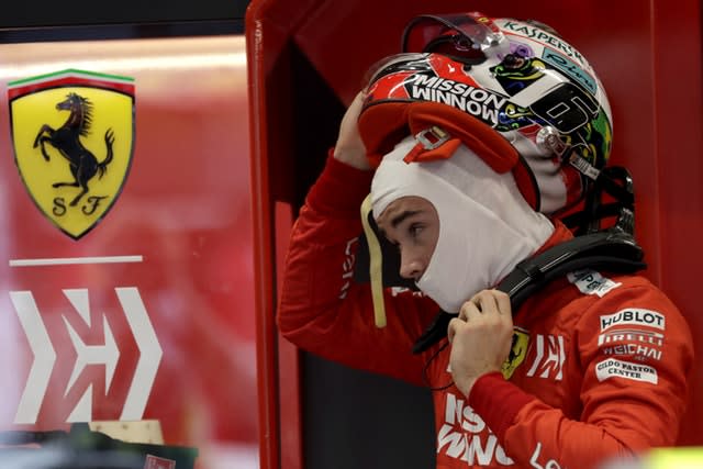 Charles Leclerc removes his helmet