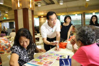 People's Action Party candidate Koh Poh Koon greets residents at Rivervale Mall on a walkabout on Sunday, 13 January. (Yahoo! photo)