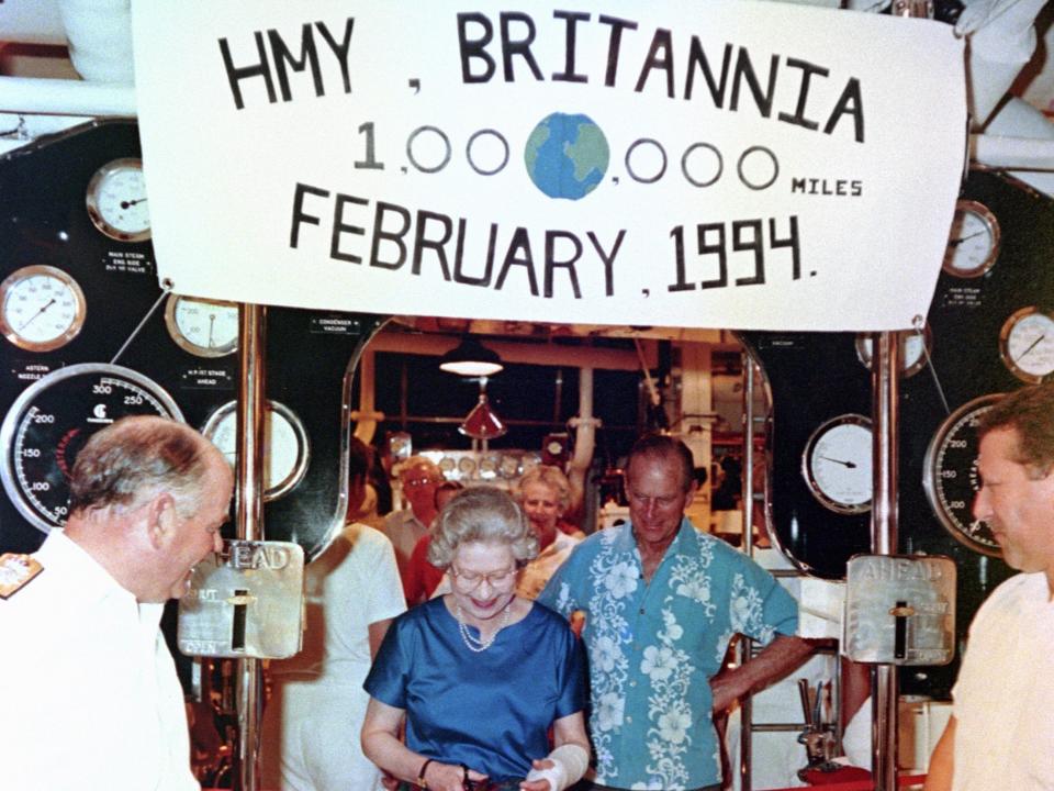 The Queen cuts a ribbon in the engine of the Royal Yacht Britannia to mark the ship's millionth mile.