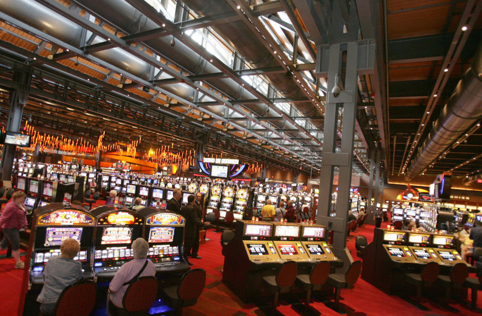 FILE - In this file photo from Friday, May 22, 2009, patrons are seen at the Sands Casino Bethlehem, in Bethlehem, Pa. A generation ago, this town was booming thanks to a manufacturing behemoth that helped build the New York City skyline, Panama Canal, battleships and countless miles of railway. Now, more than a decade after Bethlehem Steel went bankrupt, the city is reinvigorating itself through a different industry: casino gambling. (AP Photo/ Rick Smith, File)