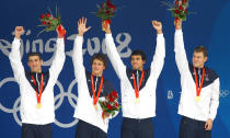 <p>(L-R) Michael Phelps, Ryan Lochte, Ricky Berens and Peter Vanderkaay pose with the gold medal on the podium during the medal ceremony for the Men’s 4 x 200m freestyle relay final during the Beijing Olympic Games on August 13, 2008. The United States won the race in a time of 6:58.56, a new World Record. (Photo: Paul Gilham/Getty Images)</p>