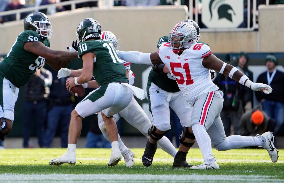 Oct 8, 2022; East Lansing, Michigan, USA; Ohio State Buckeyes defensive tackle Michael Hall Jr. (51) sacks Michigan State Spartans quarterback Payton Thorne (10) in the second quarter of the NCAA Division I football game between the Ohio State Buckeyes and Michigan State Spartans at Spartan Stadium. 