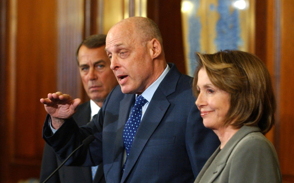 Treasury Secretary Henry Paulson, flanked by the House Minority Leader, Republican John Boehner of Ohio, and the House Speaker, Democrat Nancy Pelosi of California, discusses a bipartisan economic stimulus package on Jan. 24, 2009. (Photo: Dennis Cook/AP)