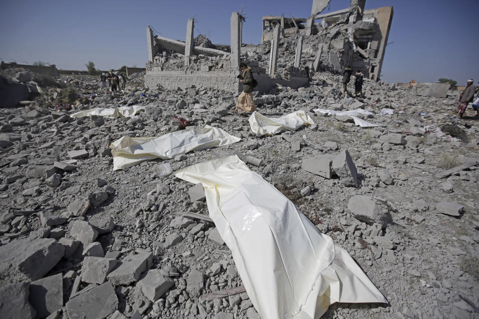 Bodies lie on the ground after being recovered from under the rubble of a Houthi detention center destroyed by Saudi-led airstrikes, that killed at least 60 people and wounding several dozen according to officials and the rebels' health ministry, in Dhamar province, southwestern Yemen, Sunday, Sept. 1, 2019. The officials said the airstrikes took place Sunday and targeted a college in the city of Dhamar, which the Houthi rebels use as a detention center. The Saudi-led coalition said it had hit a Houthi military facility used as storages for drones and missiles in Dhamar. (AP Photo/Hani Mohammed)