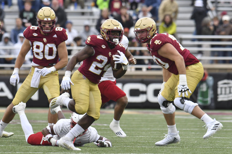 Boston College running back Pat Garwo eludes a Louisville defenseman during the first half of an NCAA college football game, Saturday, Oct. 1, 2022, in Boston. (AP Photo/Mark Stockwell)