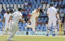 Australia's bowler Mitchell Johnson, center, celebrates after dismissing South Africa's captain Graeme Smith, right, for 4 runs on the fourth day of their their cricket test match against South Africa at Centurion Park in Pretoria, South Africa, Saturday, Feb. 15, 2014. (AP Photo/Themba Hadebe)