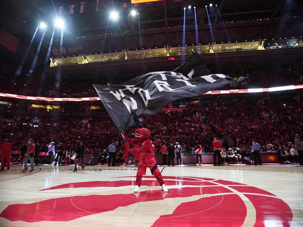 The Toronto Raptors mascot waves a flag during ceremonies before the home opener against the Washington Wizards at Scotiabank Arena. Mandatory Credit: John E. Sokolowski-USA TODAY Sports