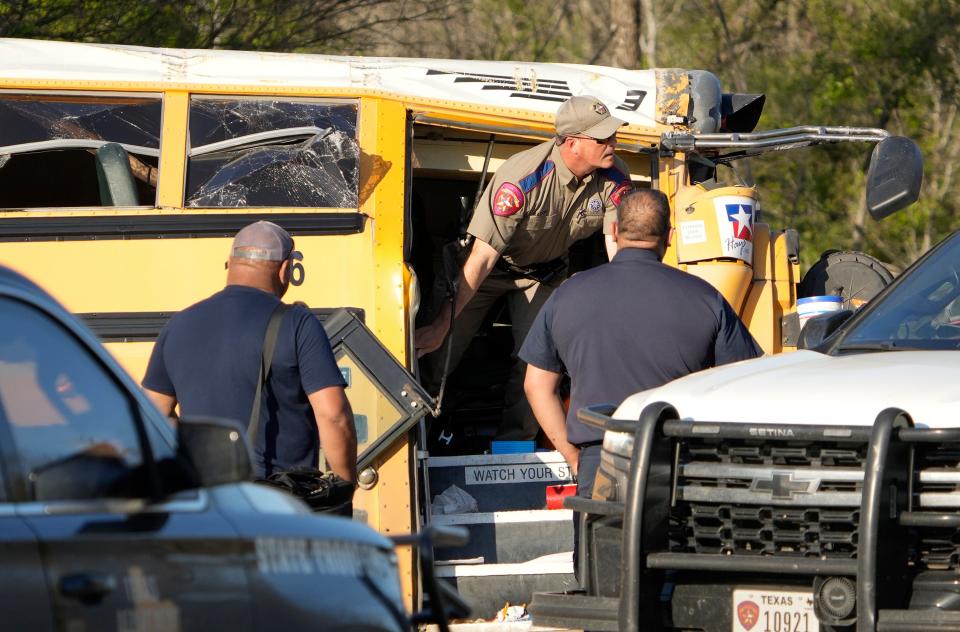 A Texas Department of Public Safety trooper checks out the wrecked school bus after the fatal crash March 22 in Bastrop County.