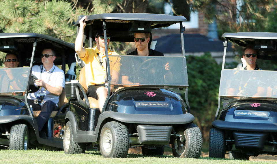 <p>Later on Tuesday, Harry hits the green behind the wheel of a golf cart.</p>