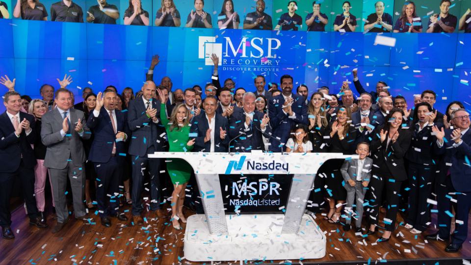 John Ruiz rings the bell to celebrate his company being listed on the NASDAQ stock exchange.