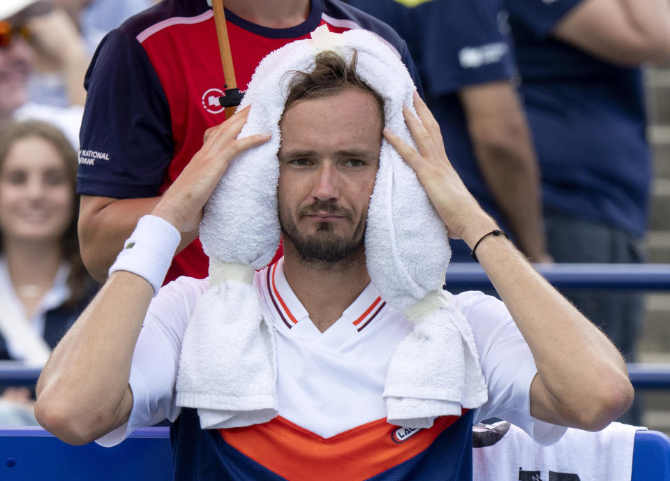Daniil Medvedev, of Russia, puts a towel on his head just before being defeated by Alex de Minaur, of Australia, in men’s quarterfinal tennis match action at the National Bank Open in Toronto, Friday, Aug. 11, 2023. (Frank Gunn/The Canadian Press via AP)