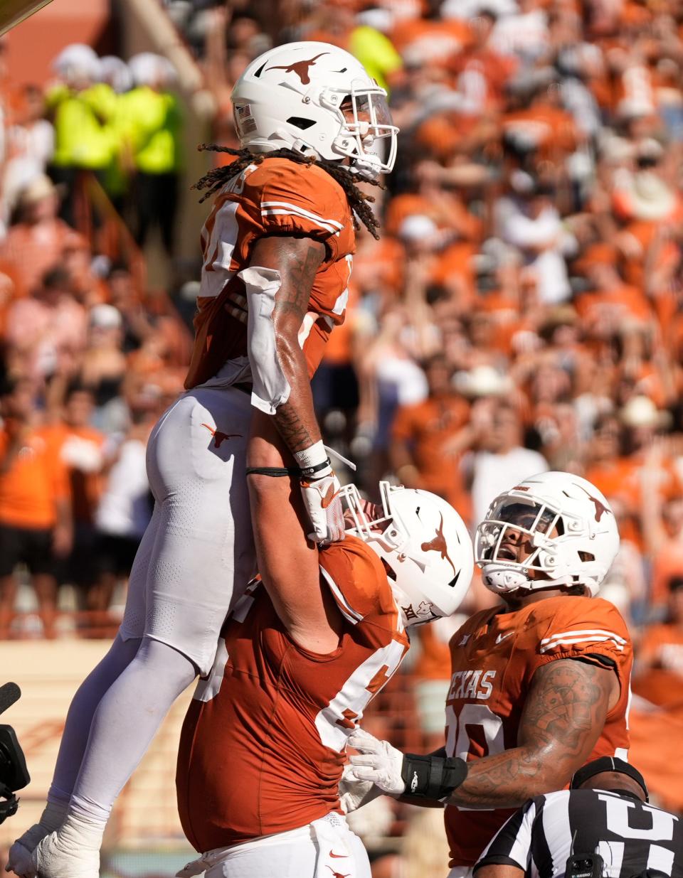 Texas running back Jonathon Brooks gets a lift after a third-quarter touchdown Saturday against Kansas. Brooks had 20 carries for 217 yards and two scores.