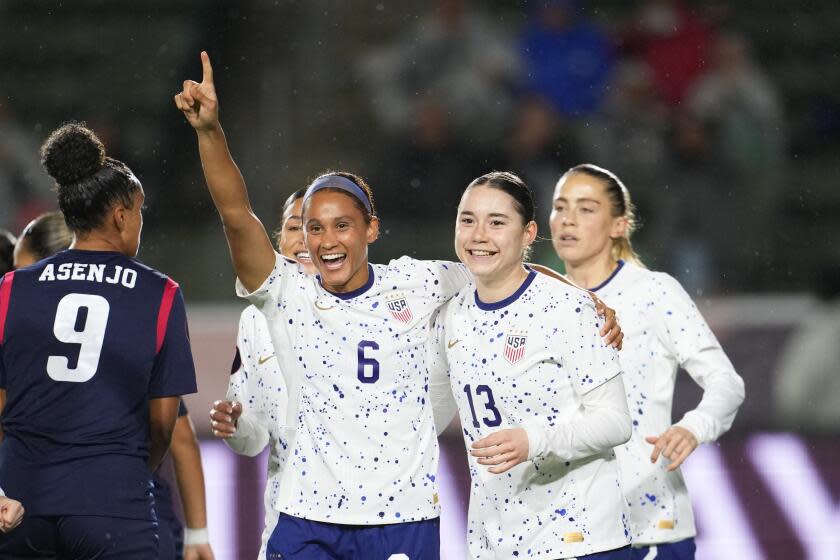 Lynn Williams holds up one finger in the air and embraces Olivia Moultrie after Moultrie scored for the U.S.