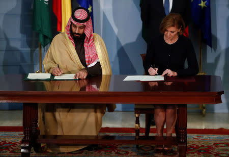 Saudi Arabia's Crown Prince Mohammed bin Salman exchanges signs documents with Spain's Defence Minister Maria Dolores de Cospedal during a ceremony at the Moncloa Palace in Madrid, Spain, April 12, 2018. REUTERS/Juan Medina