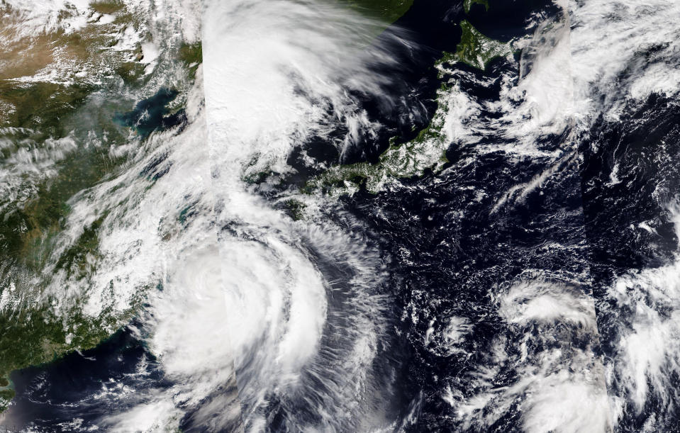 This Sunday, Sept, 4, 2022 image released by NASA shows a composite image of Typhoon Hinnamnor, lower left, moving gradually northward into the East China Sea. Cities in eastern China suspended ferry services and classes and flights were canceled in Japan on Sunday as Typhoon Hinnamnor, the strongest global storm this year, blew its way past Taiwan and the Koreas with fierce winds and heavy rains. (NASA Worldview, Earth Observing System Data and Information System (EOSDIS) via AP)