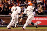 SAN FRANCISCO, CA - OCTOBER 24: Pablo Sandoval #48 of the San Francisco Giants celebrates with teammate Marco Scutaro #19 after scoring a two run home run to left field against Justin Verlander #35 of the Detroit Tigers in the third inning during Game One of the Major League Baseball World Series at AT&T Park on October 24, 2012 in San Francisco, California. (Photo by Christian Petersen/Getty Images)