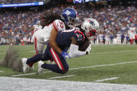 New York Giants cornerback Aaron Robinson (33) brings down New England Patriots wide receiver Kristian Wilkerson during the first half of a preseason NFL football game Thursday, Aug. 11, 2022, in Foxborough, Mass. (AP Photo/Michael Dwyer)