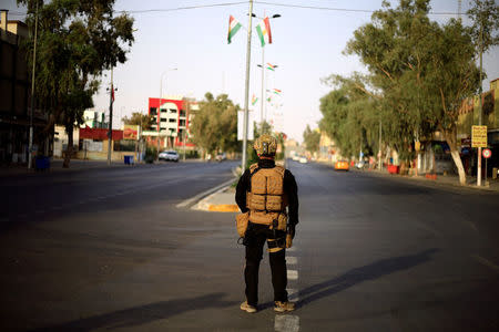 An Iraqi SWAT trooper stands guard on a street during Kurds independence referendum in Kirkuk, Iraq September 25, 2017. REUTERS/Thaier Al-Sudani