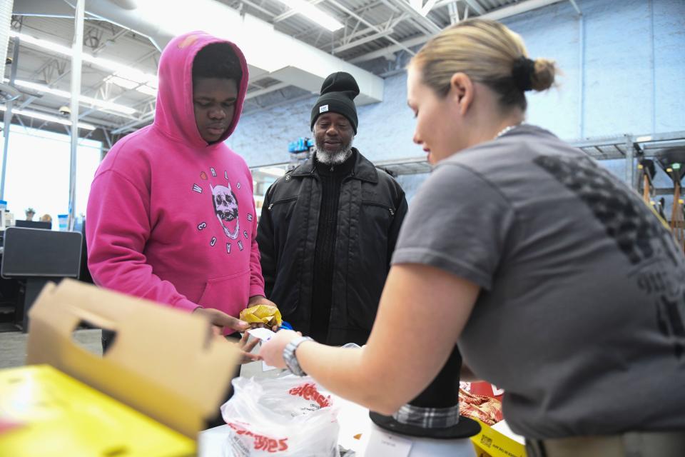 John Miniwether (center) and his son Alijah get breakfast during the Columbia County Sheriff's Office Day with a Deputy at Walmart on Thursday, Dec. 21, 2023.