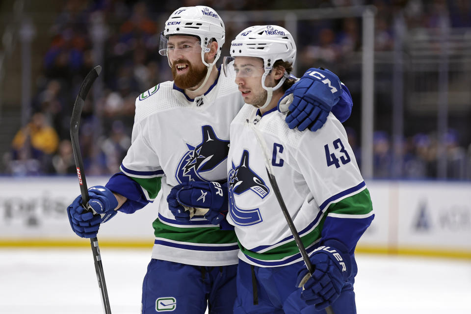 Vancouver Canucks defenseman Quinn Hughes (43) is congratulated by Filip Hronek for a goal against the New York Islanders during the first period of an NHL hockey game Tuesday, Jan. 9, 2024, in Elmont, N.Y. (AP Photo/Adam Hunger)