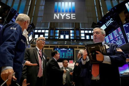 Traders work on the floor of the New York Stock Exchange (NYSE) in New York, U.S., October 13, 2017. REUTERS/Brendan McDermid