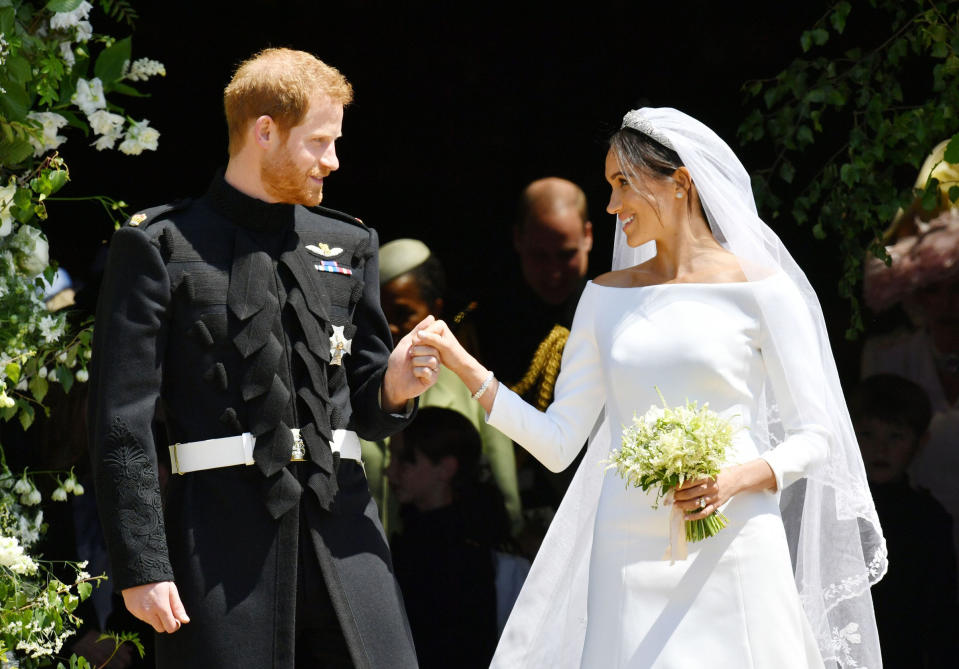 Prince Harry, Duke of Sussex and Meghan, Duchess of Sussex emerge from the West Door of St George's Chapel, Windsor Castle, in Windsor, on May 19, 2018.